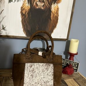 Ladies conceal carry genuine leather with cow hide accents.